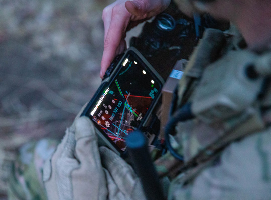 A Soldier from the 2-506, 101st Airborne Division checks his Nett Warrior end user device (EUD) during a full mission test event at a Soldier Touchpoint at Aberdeen Proving Ground, MD in February 2021.